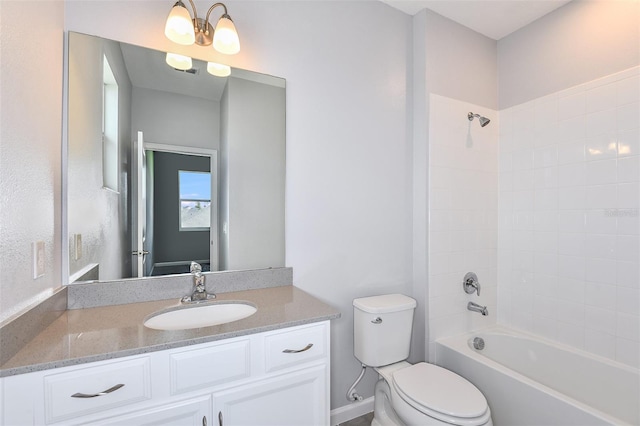 full bathroom with tiled shower / bath combo, vanity, and toilet