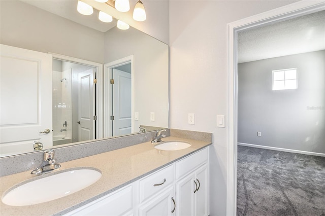 bathroom with vanity, a textured ceiling, and tiled shower / bath