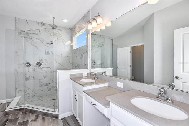 bathroom featuring a tile shower and vanity