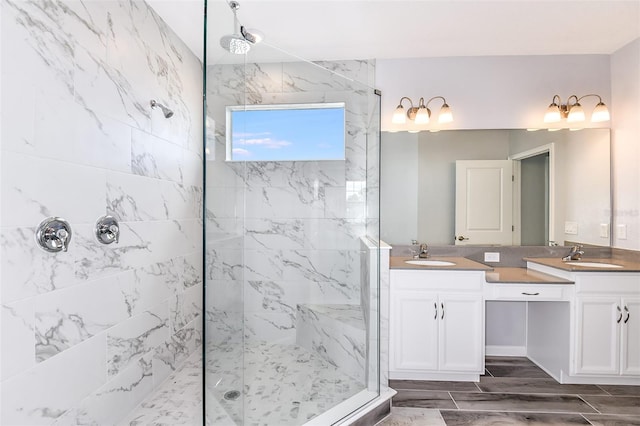 bathroom featuring tiled shower and vanity