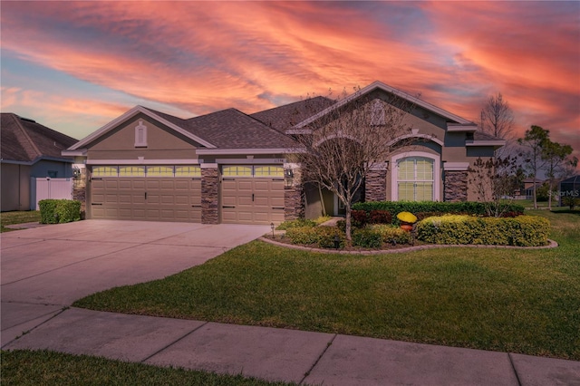 view of front of house featuring a garage and a lawn