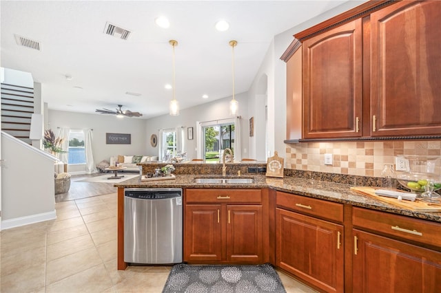 kitchen featuring dishwasher, decorative light fixtures, plenty of natural light, and sink