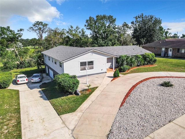 single story home featuring a garage and a front lawn