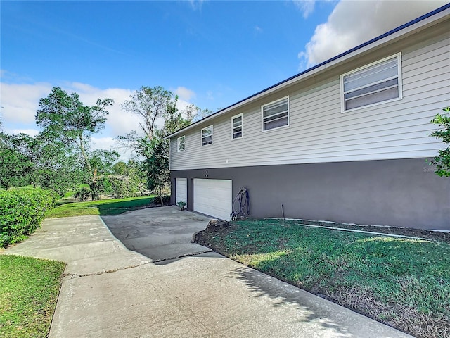 view of home's exterior with a yard and a garage