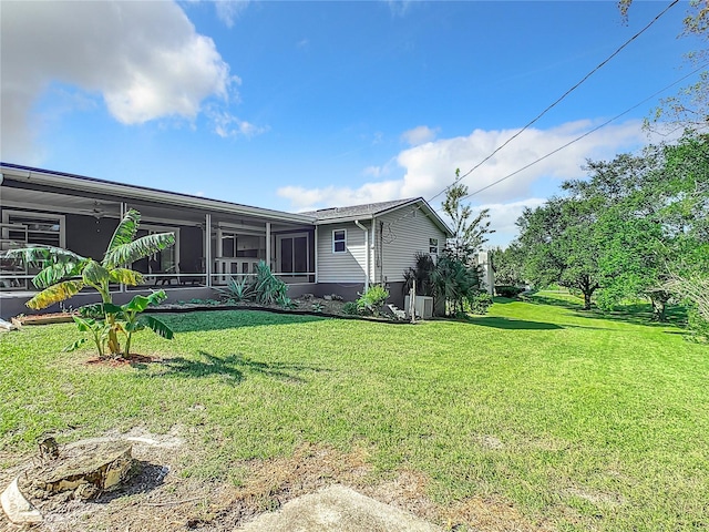 2281 E Union Cir, Deltona, FL 32725 - rear view of property with a yard and a sunroom