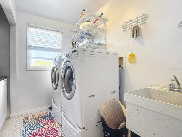 2281 E Union Cir, Deltona, FL 32725 - clothes washing area with light tile patterned floors, a sink, baseboards, washer and dryer, and laundry area