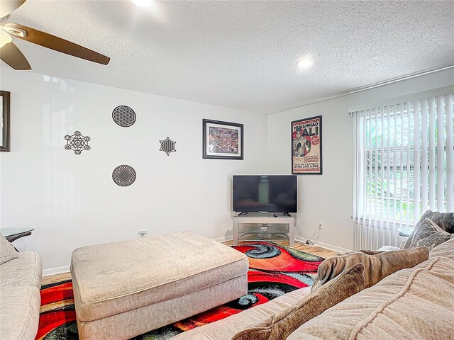 2281 E Union Cir, Deltona, FL 32725 - living area featuring a textured ceiling, wood finished floors, a ceiling fan, and baseboards