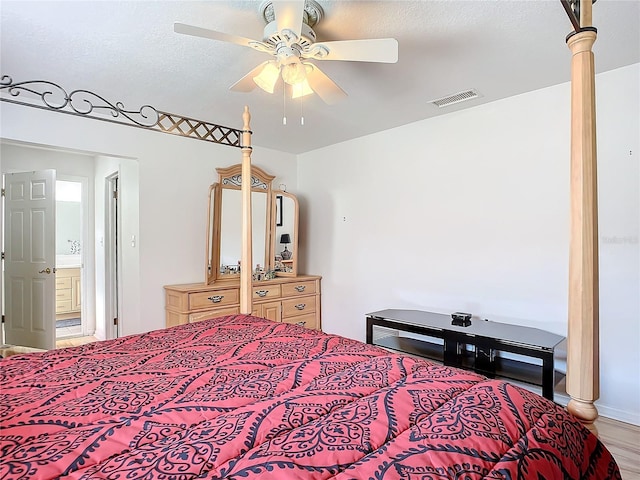 bedroom with ceiling fan, a textured ceiling, and light wood-type flooring