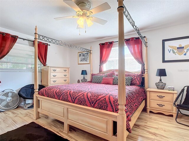 2281 E Union Cir, Deltona, FL 32725 - bedroom featuring light wood finished floors, a textured ceiling, and ceiling fan