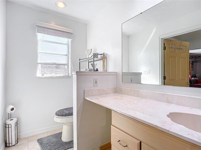 2281 E Union Cir, Deltona, FL 32725 - bathroom featuring tile patterned floors, toilet, vanity, and baseboards
