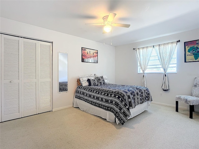 carpeted bedroom featuring a closet and ceiling fan