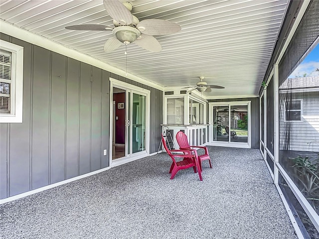 sunroom / solarium featuring ceiling fan