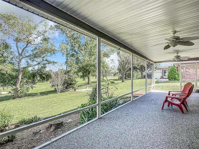 unfurnished sunroom with ceiling fan