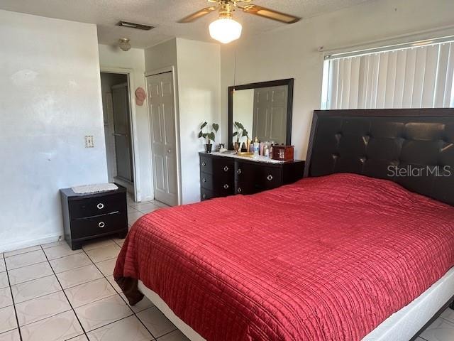 tiled bedroom with ceiling fan