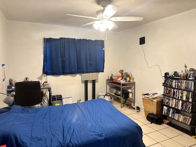 bedroom featuring light tile patterned flooring and ceiling fan