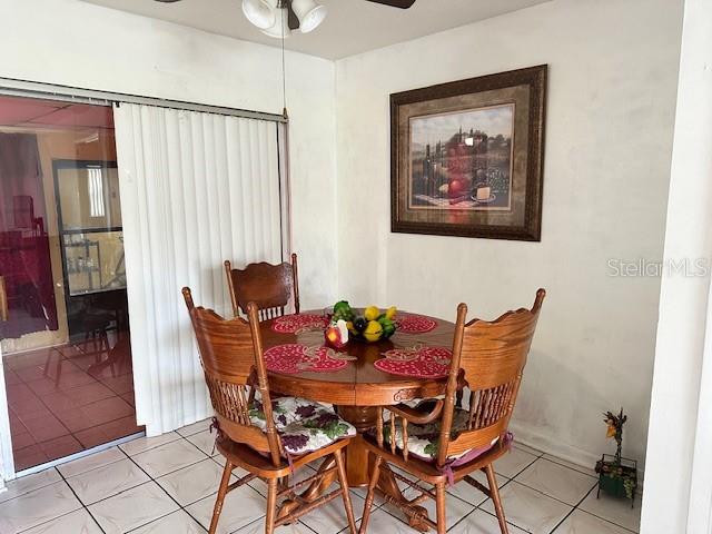 tiled dining area featuring ceiling fan