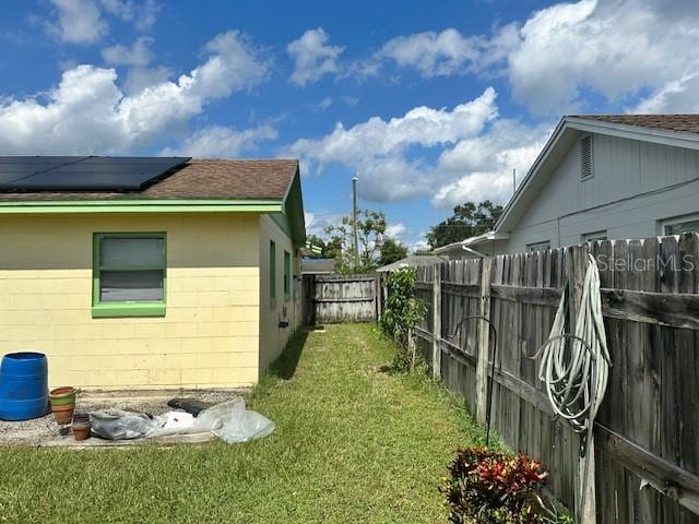 view of side of property with a yard