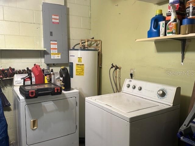 laundry area with electric water heater, electric panel, and separate washer and dryer