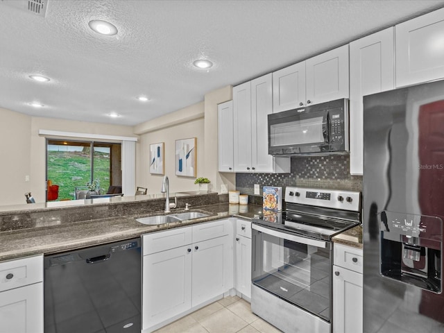 kitchen with white cabinetry, sink, a textured ceiling, decorative backsplash, and black appliances