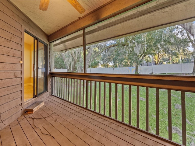 wooden terrace with ceiling fan and a yard