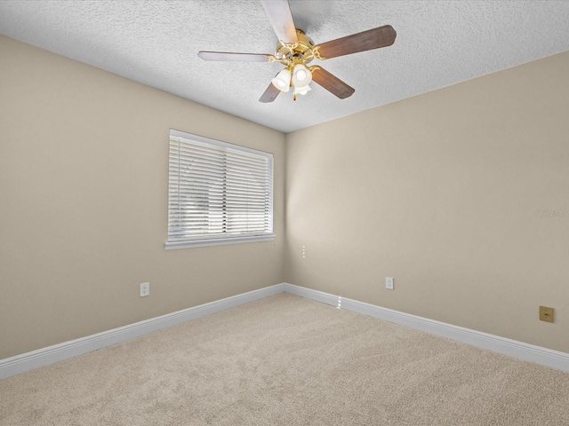 carpeted spare room with ceiling fan and a textured ceiling