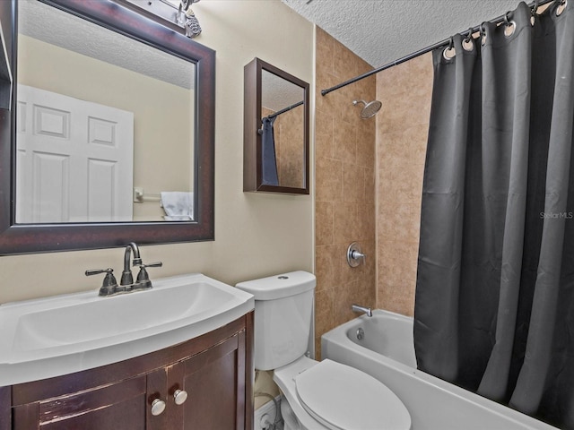 full bathroom featuring shower / tub combo with curtain, vanity, a textured ceiling, and toilet