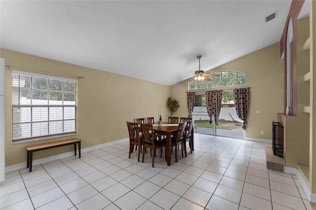 dining area with light tile patterned flooring, ceiling fan, a healthy amount of sunlight, and lofted ceiling