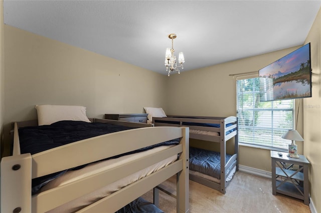 carpeted bedroom with a notable chandelier