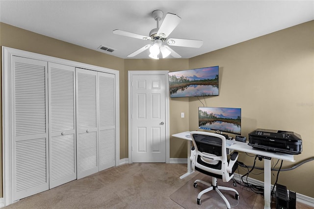 carpeted office featuring ceiling fan