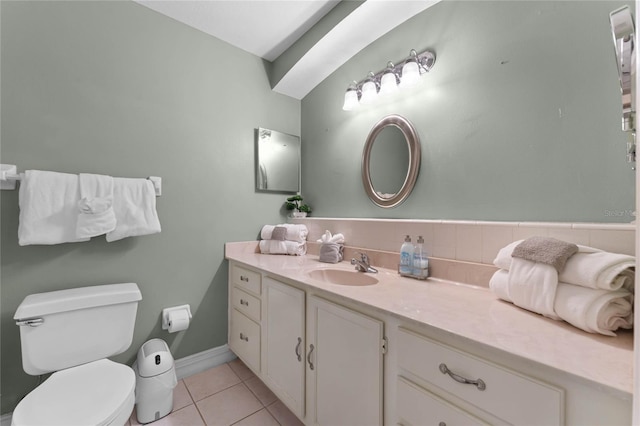 bathroom featuring vanity, tile patterned floors, and toilet