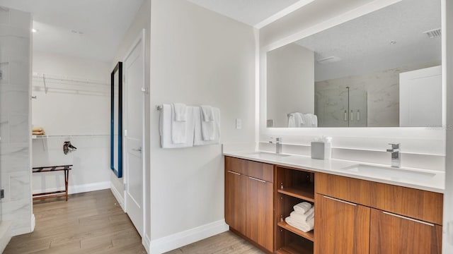 bathroom with vanity, hardwood / wood-style flooring, and an enclosed shower