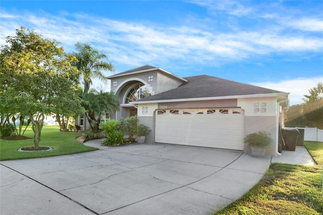 view of front of house featuring a garage and a front lawn