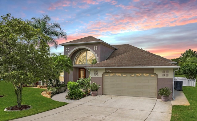 view of front facade with a garage and a yard