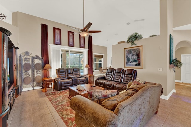 living room featuring ceiling fan, light tile patterned floors, and high vaulted ceiling