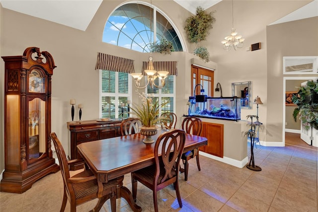 tiled dining area featuring high vaulted ceiling and a chandelier