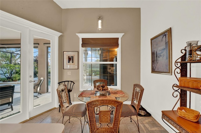 dining area featuring french doors and light tile patterned floors