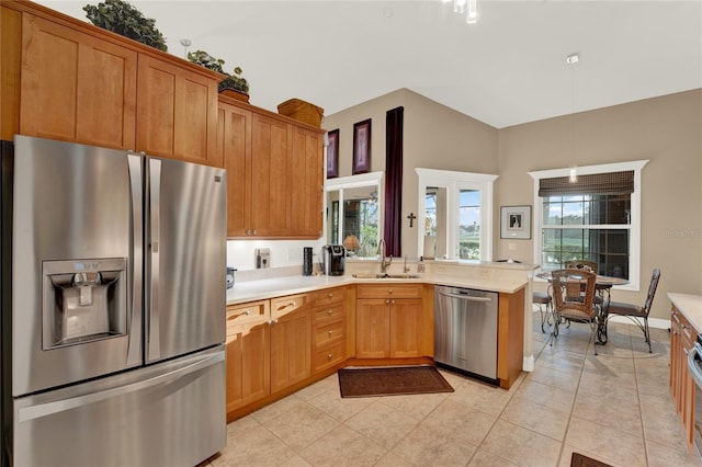 kitchen featuring stainless steel appliances, hanging light fixtures, a healthy amount of sunlight, and sink