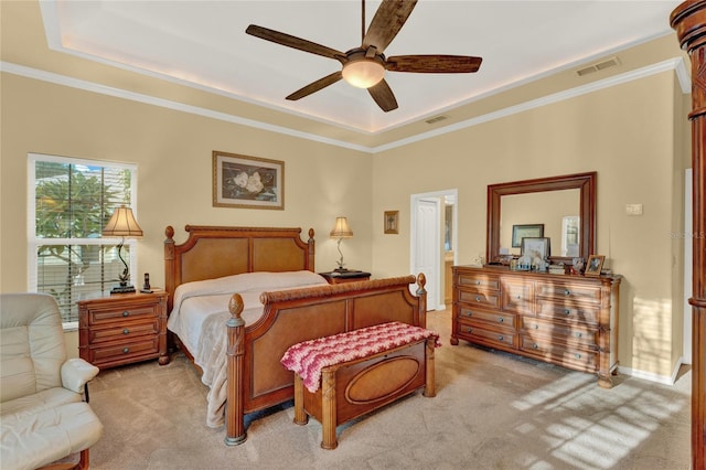 carpeted bedroom featuring a tray ceiling, ceiling fan, and ornamental molding