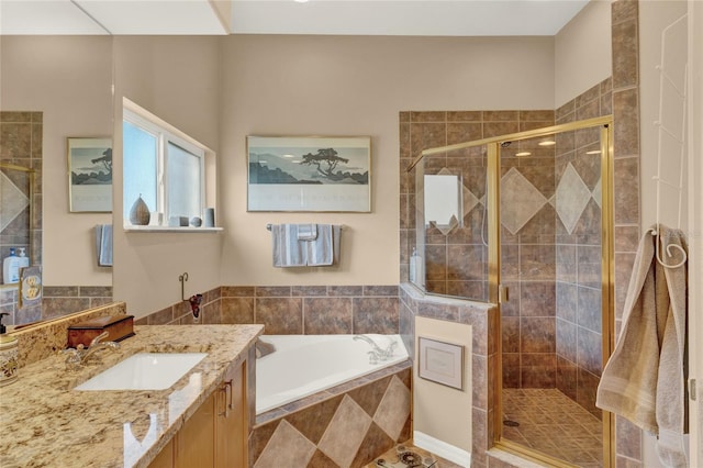 bathroom with vanity and independent shower and bath