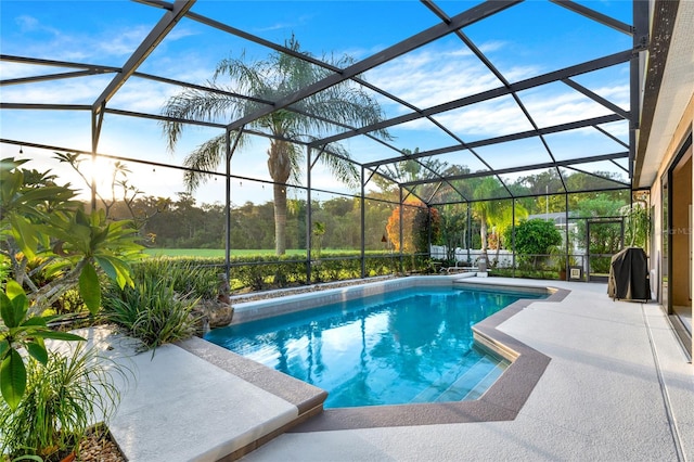 view of pool featuring a patio and glass enclosure