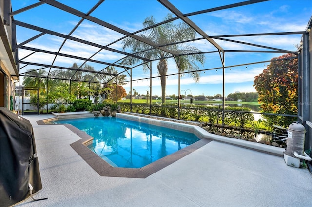 view of swimming pool featuring glass enclosure, a grill, and a patio