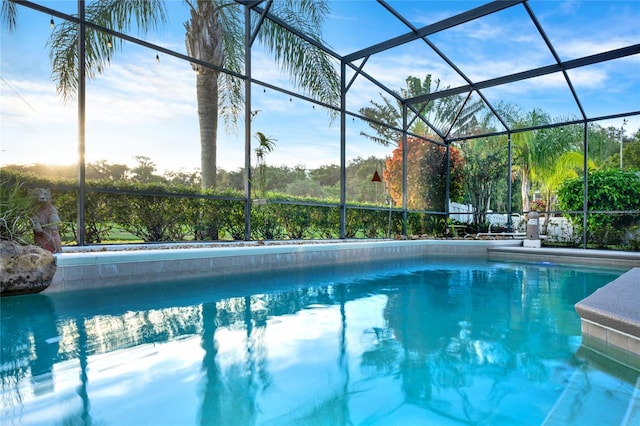 view of pool featuring glass enclosure