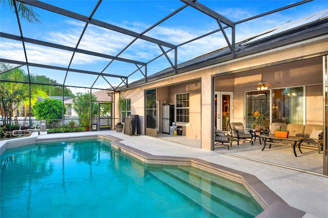 view of pool featuring a lanai, ceiling fan, and a patio