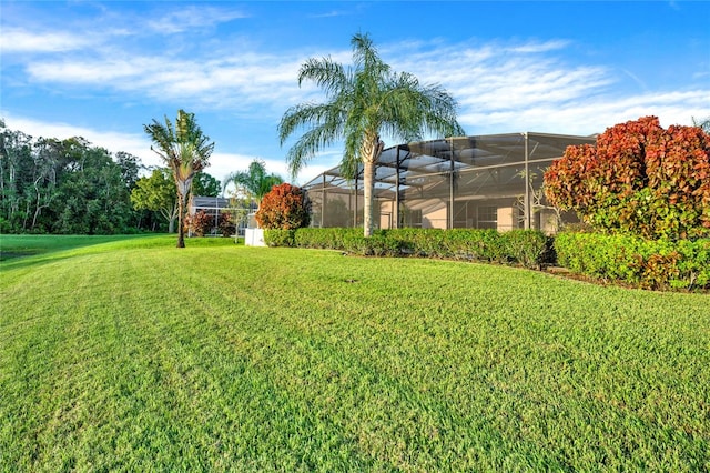 view of yard with glass enclosure