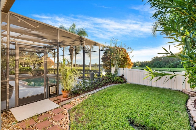 view of yard featuring a fenced in pool and a lanai