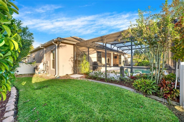 back of house with a yard and glass enclosure