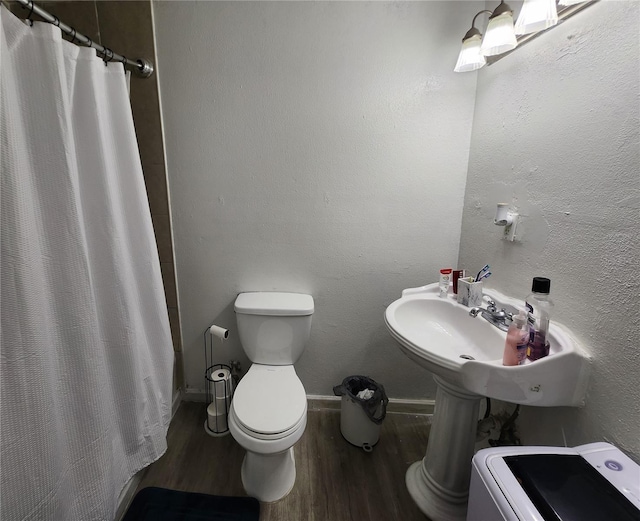 bathroom featuring toilet, hardwood / wood-style floors, and a shower with shower curtain