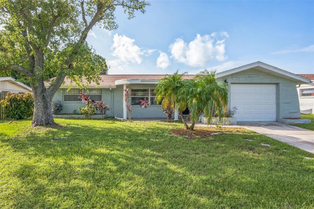 ranch-style home with a front lawn and a garage