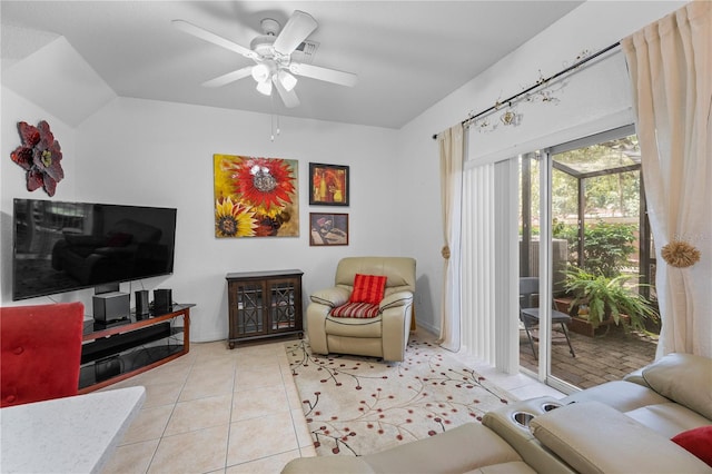 living room featuring vaulted ceiling, ceiling fan, and light tile patterned floors