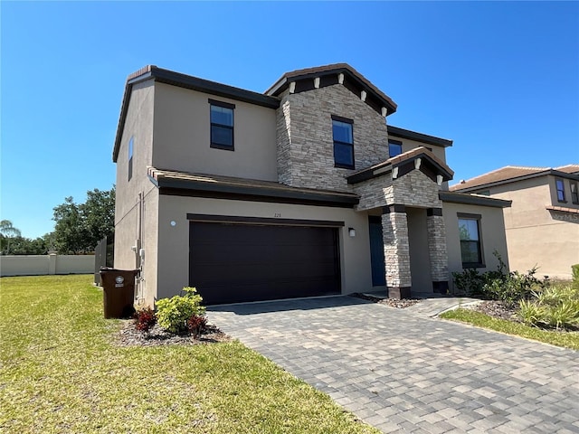 226 Macaulays Cv, Haines City, FL 33844 - modern home with stucco siding, a garage, stone siding, and decorative driveway